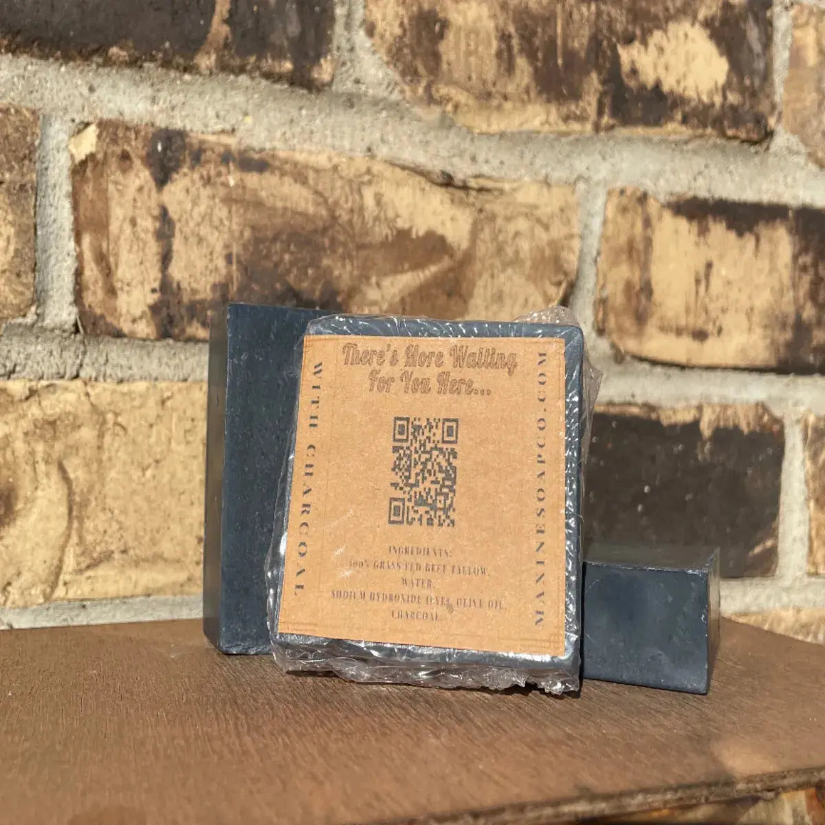 Back of wrapped Beef Tallow Charcoal Bar Soap by Maxine’s, 3.5 oz (99 g), label shows clear ingredient list and net weight.