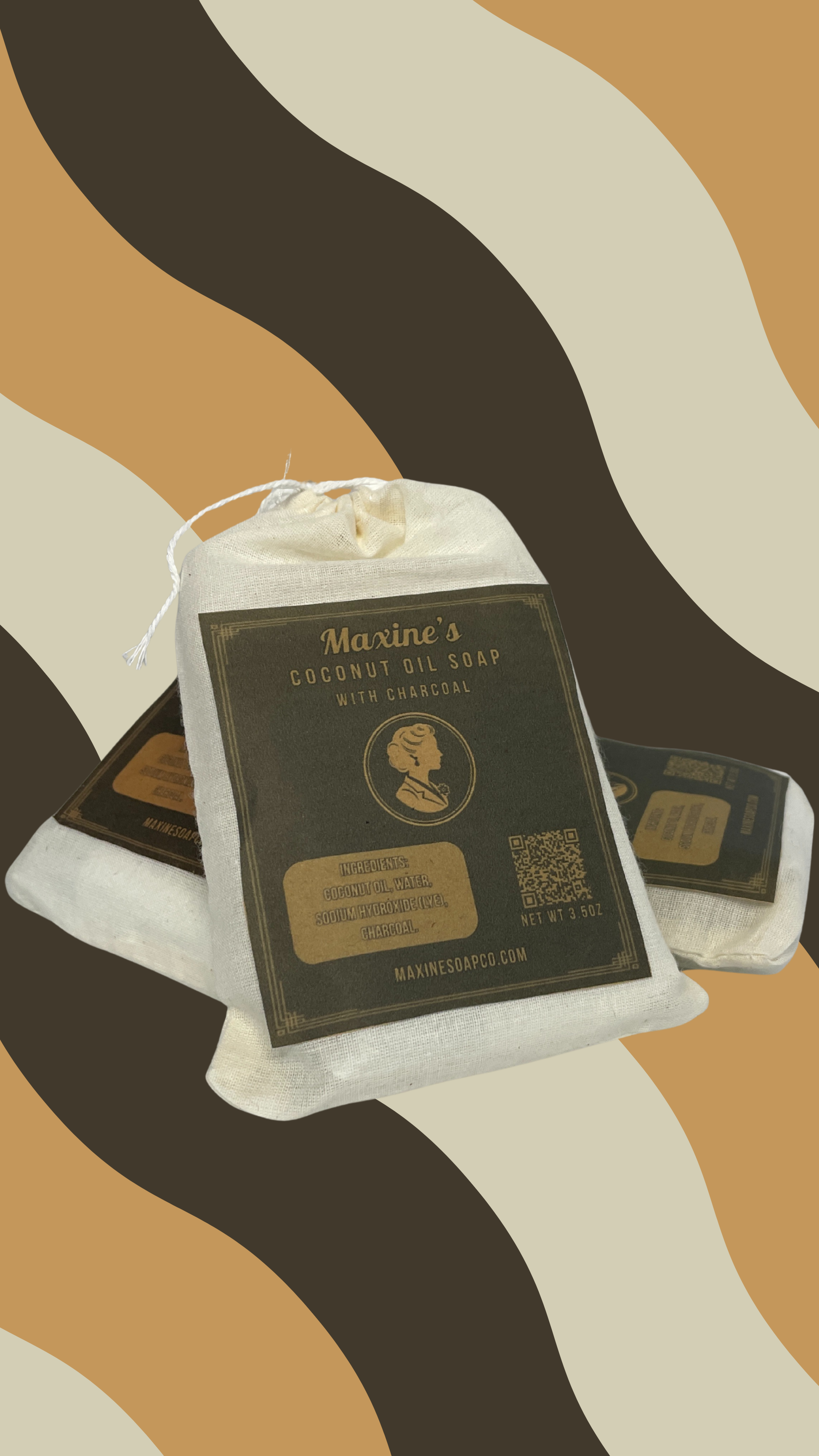 Three Maxine's coconut oil charcoal bar soaps stacked showing muslin pouch packaging handmade in Iowa