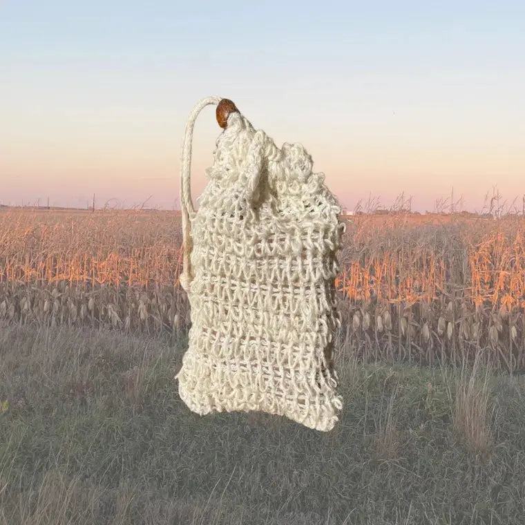 Natural sisal soap saver pouch, 3.5 × 5.5 in, drawstring with wooden bead; helps use leftover soap pieces without waste.